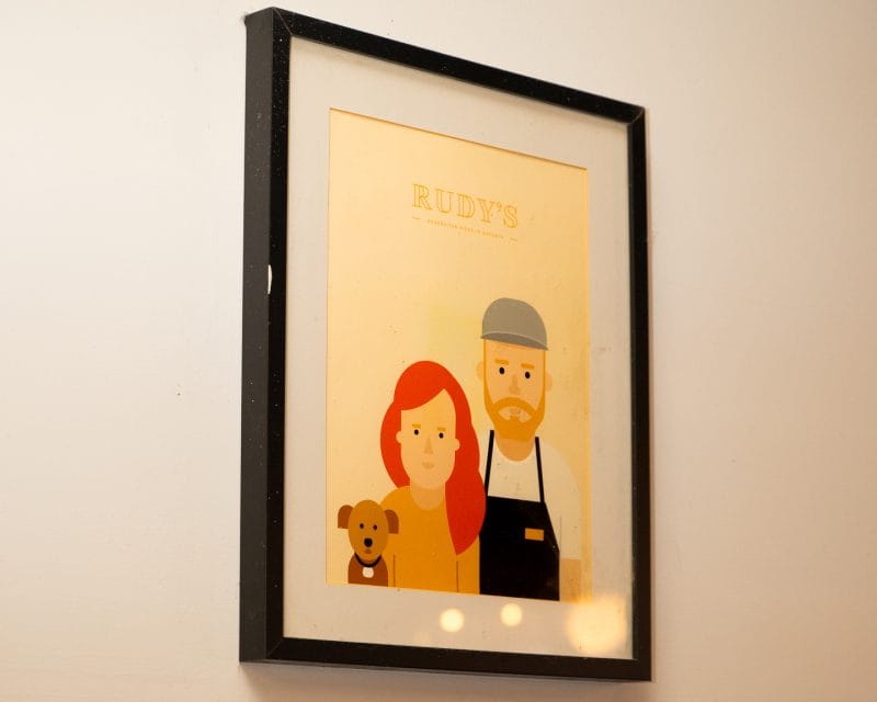 rudy's poster with two people and a dog