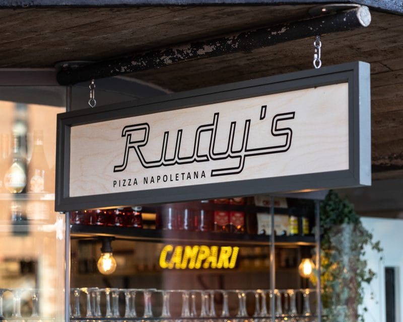 rudy's pizza sign and bar area behind