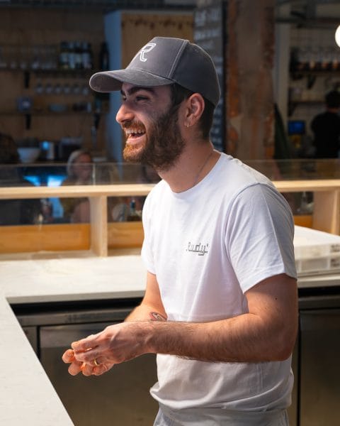 male staff smiling at rudy's pizza restaurant