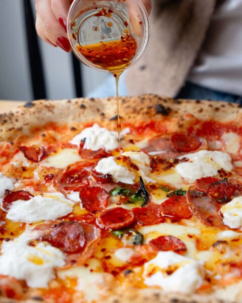 Rudy’s triple pepperoni Neapolitan pizza topped with stracciatella and chilli honey