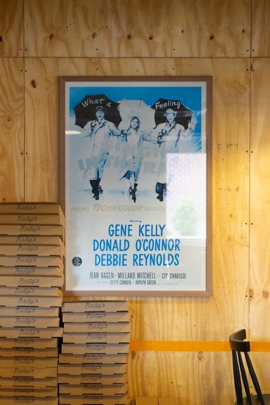 pizza boxes piled up and decorative poster