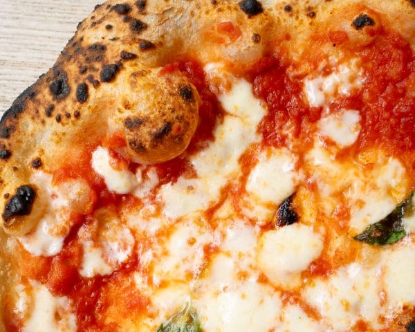 tomato base neapolitan pizza with cheese and basil