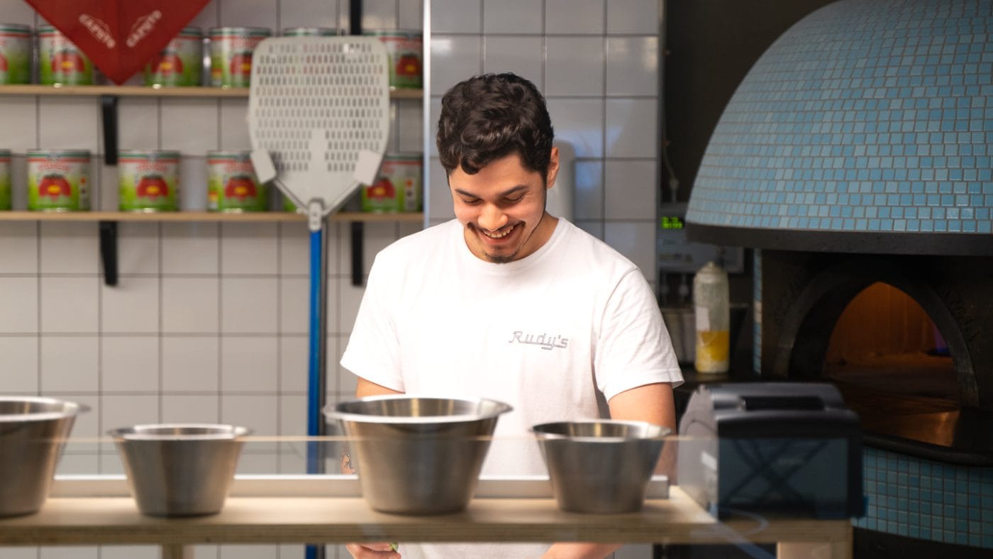 kitchen staff preparing neapolitan pizza