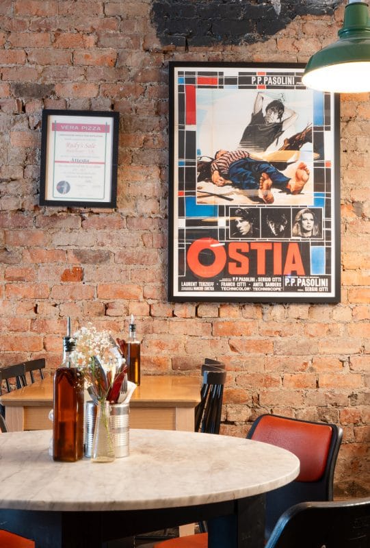 rudy's restaurant table with decorative frames on the wall