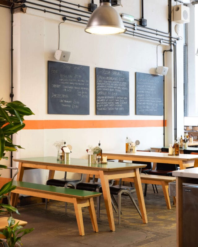 nterior of Rudy’s Pizza on Peter Street showing seating area, counter, and casual dining atmosphere