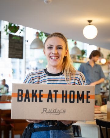 girl holding box with bake at home neapolitan pizza