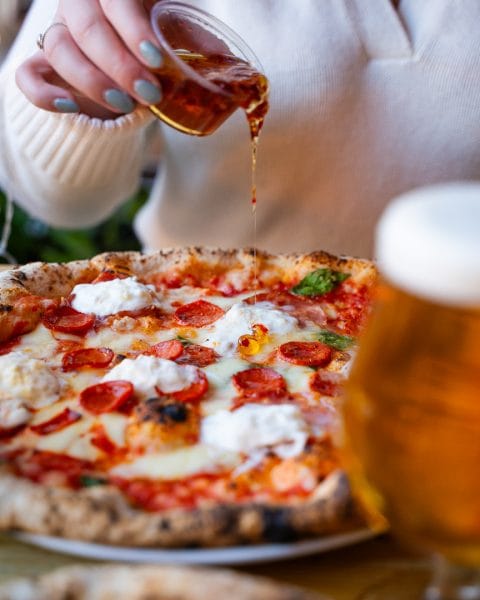 chilli oil poured over pepperoni pizza