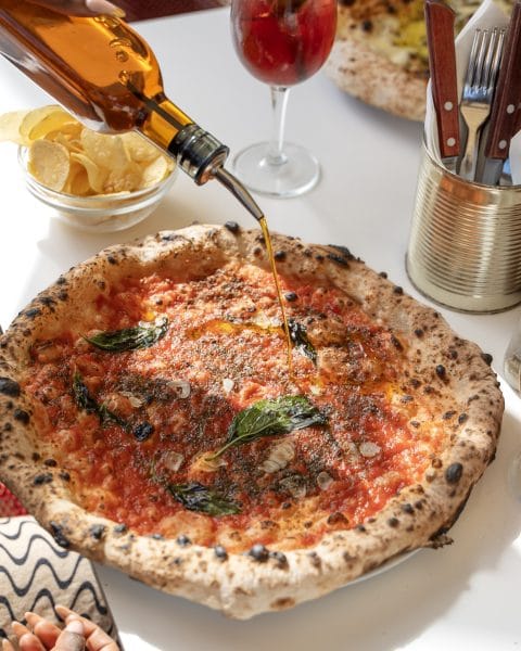 Rudy's marinara pizza with marinara sauce, garlic, basil and olive oil