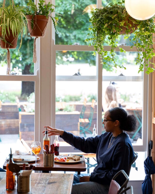 Interior of Rudy’s Clapham Common with casual seating, tables, and chairs, showing a bright, welcoming pizza restaurant environment.
