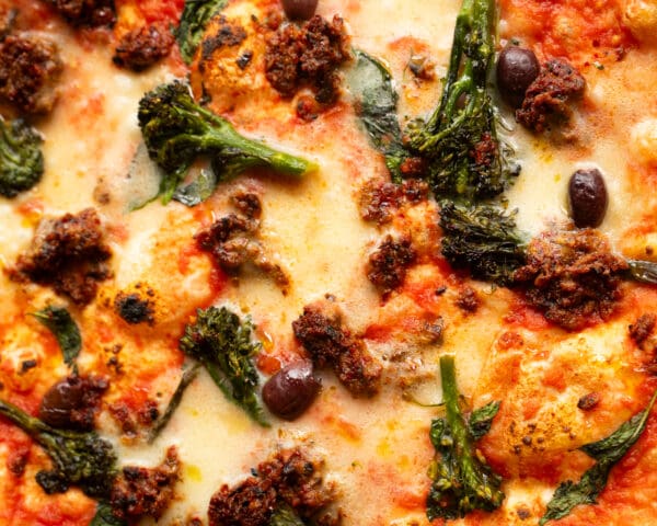 pizza with cheese broccoli and olive topping