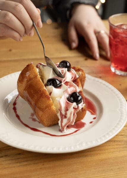 person eating italian dessert with spoon